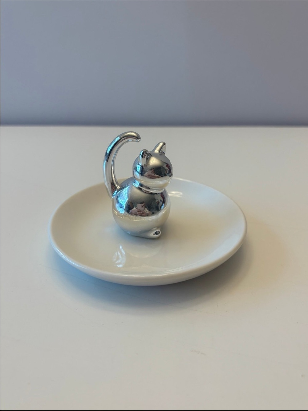 Silver Cat Ring Holder on White Ceramic Dish